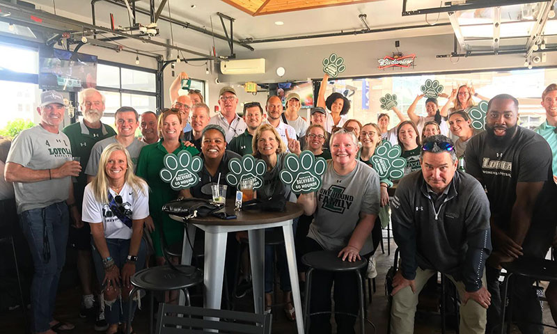 Loyola staff, coaches, and supporters gathered at a Loyola-alum-owned bar to watch Women's Lacrosse in the NCAA Tournament