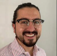 Headshot image of Dr. Hastings wearing glasses and a striped shirt