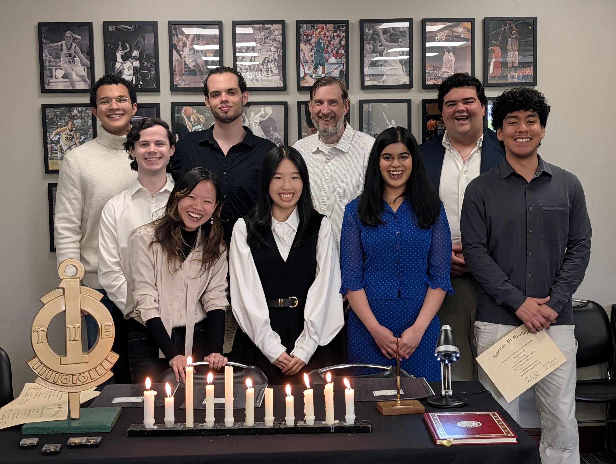 A group of students post together at an induction ceremony.