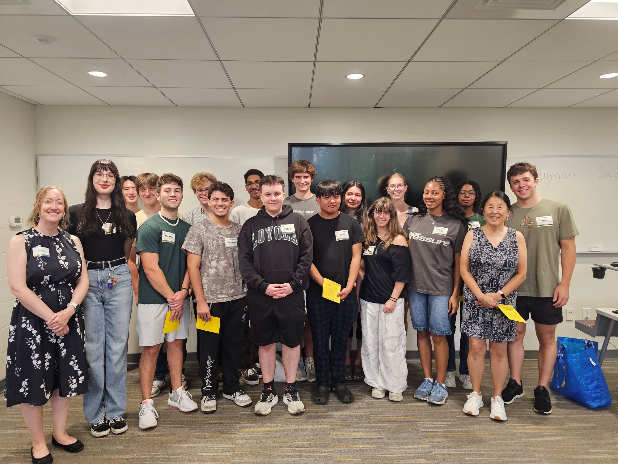 A group of Loyola students pose with classmates and faculty.