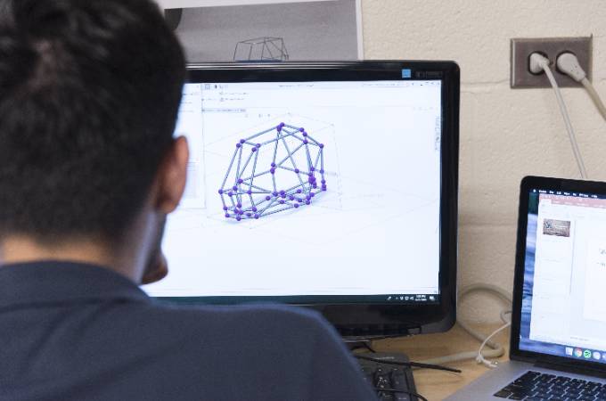 student looking a mechanical diagram on a computer screen