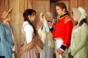 4 women and 1 man wearing Victorian clothing talking