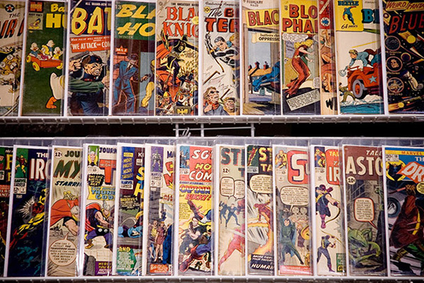 Multiple overlapping comic books on a display shelf