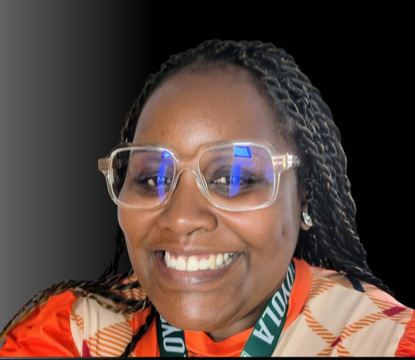 Headshot of Evona Hebb with glasses, orange shirt, and long braids