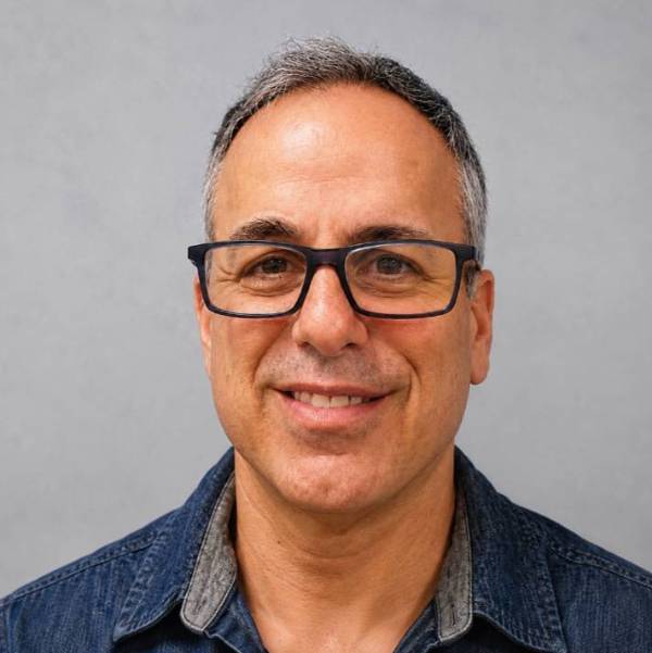 Adam Lippe headshot with glasses