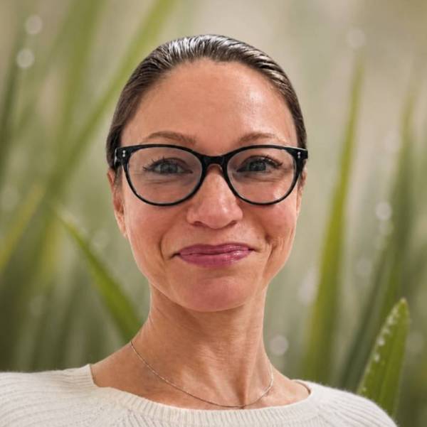 Catherine Newberry headshot with grass background