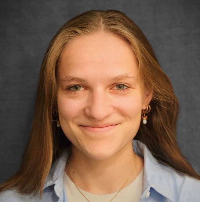 Kirby Povilaitis headshot in blue collared shirt
