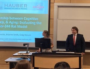 students at lectern in front of hauber slide