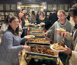 students on either side of a festive food buffet