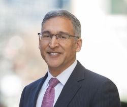 man in blue suit and purple tie