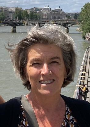 Catherine Savell smiling with city and river in background