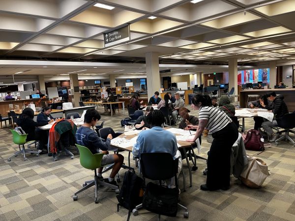 students around tables in the library