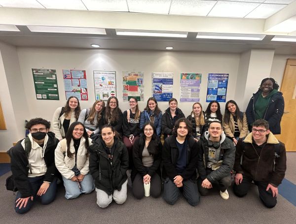 students posing in front of the final project posters
