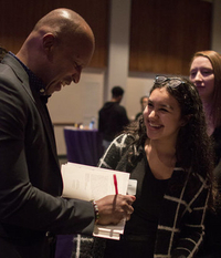Bryan Stevenson signs a copy of his book 'Just Mercy' for Loyola students