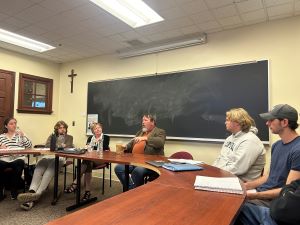 Brian Turner speaker to college students at a large round table