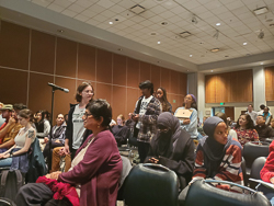 students asking questions in front of a microphone