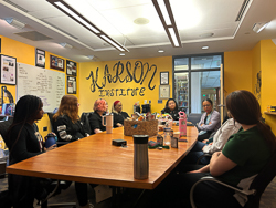 Students around a table at the Karson Institute