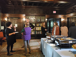 faculty standing around at a reception