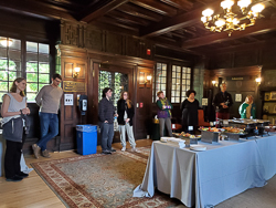 Faculty listening at a reception