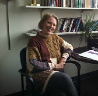 Dr. Vann smiling at her desk