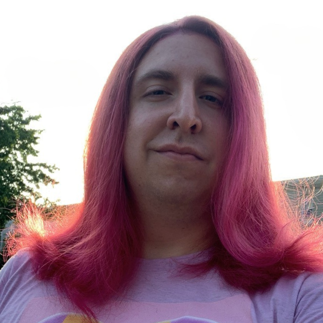 Jess Miller smiling at the camera with straight, pink hair