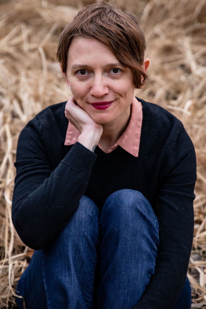 Amie Whittemore sitting in facing the camera