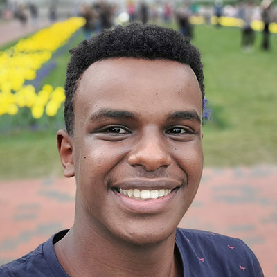 Malcolm headshot among a field of tulips