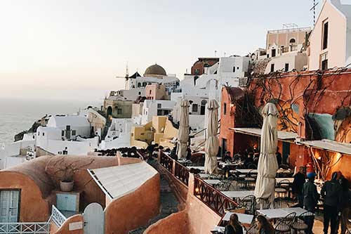 Old hillside town with clay and stone buildings overlooking the water in Italy