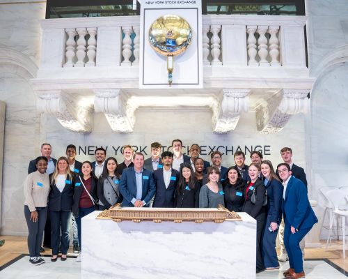 A group of Loyola alumni and students at the New York Stock Exchange