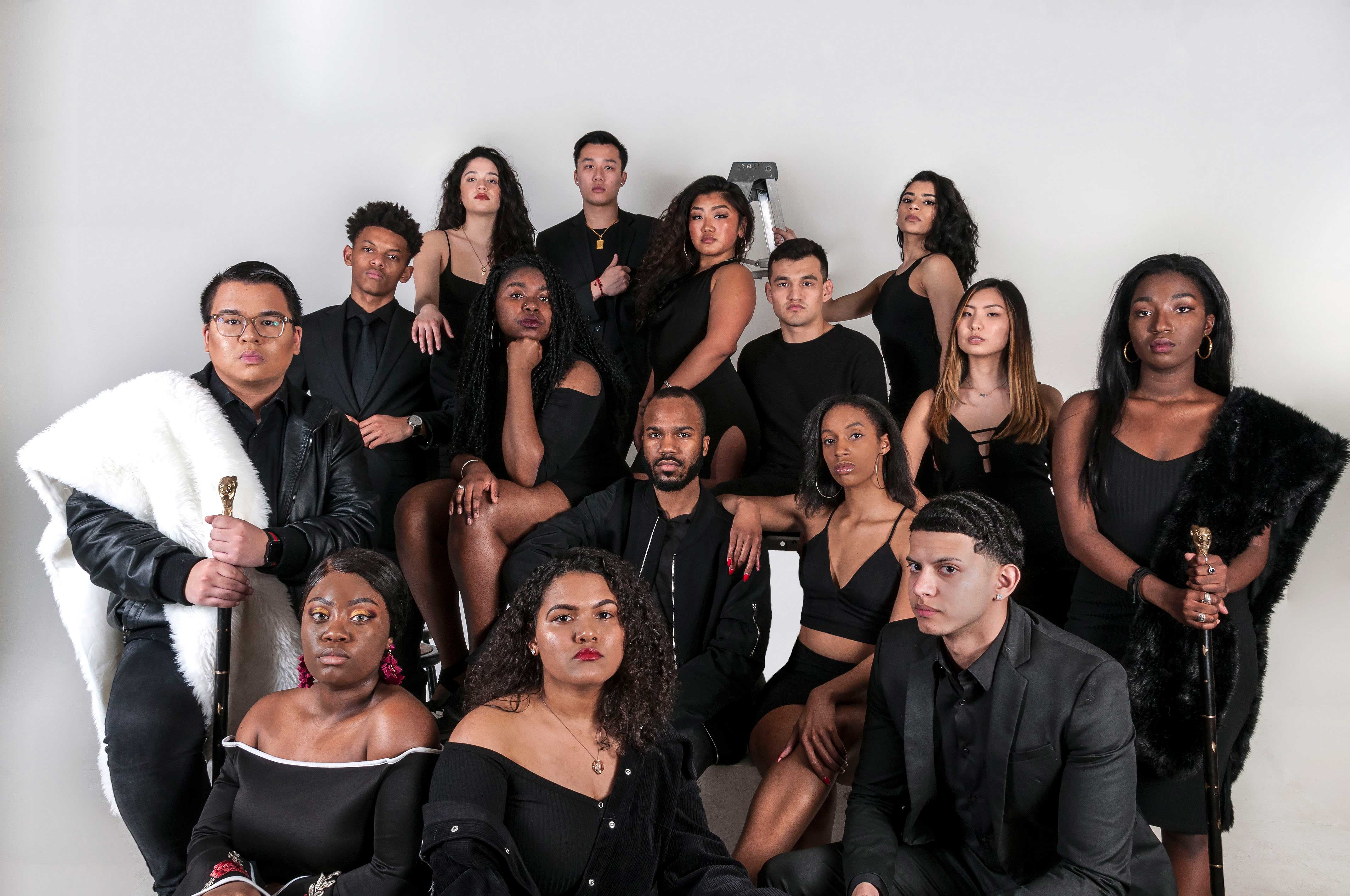 The BSA Fashion Show cast posing for a serious promotional photo in all black outfits against a plain white background