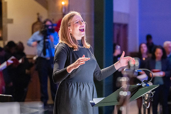 Director of Chapel Choir, Laura McCormack, conducting the Chapel Choir during Lessons and Carols 2024