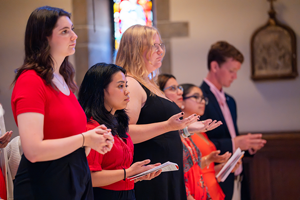 Students praying during Mass of the Holy Spirit 2024