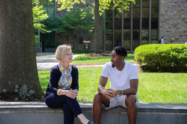 faculty and student having conversation outdoors