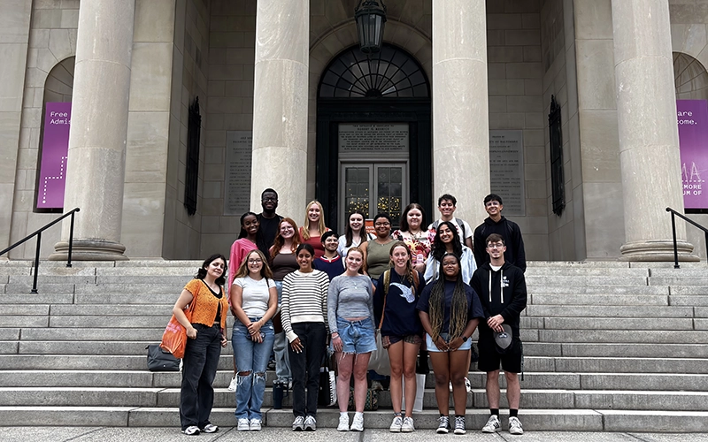 Photo of 2023-2024 CCSJ Student and Professional Staff in Front of Humanities Porch
