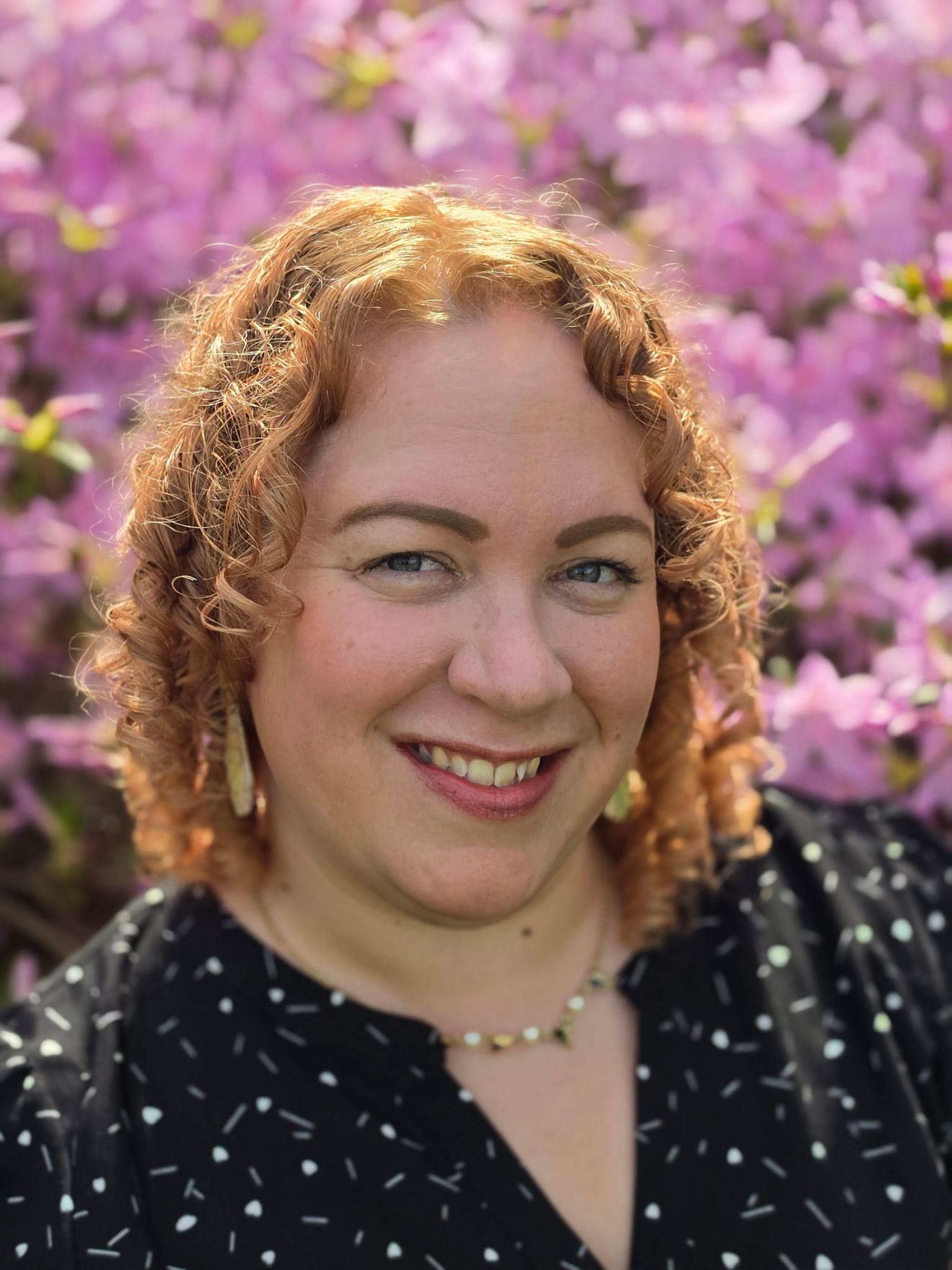 professional woman in front of pink flowers