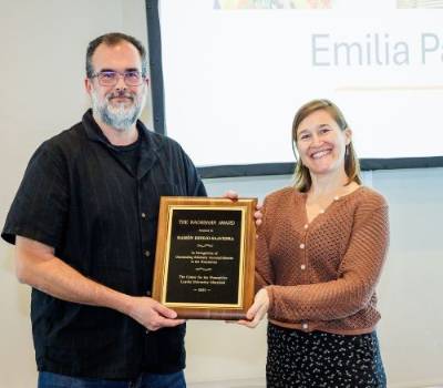 man and woman holding an engraved plaque