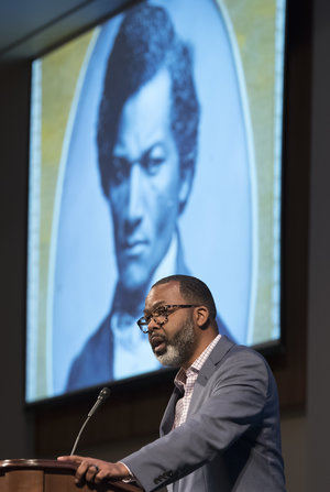 Dr. Maurice Wallace in front of portrait of Douglass