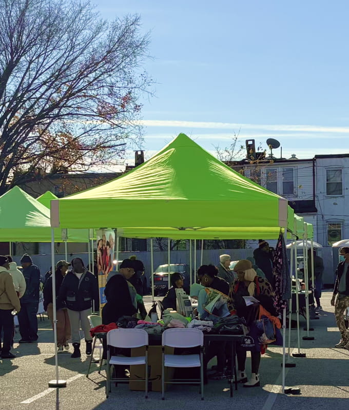 An outdoor health clinic in the York Road Corridor, where neighborhood residents stop by to receive information about health services.