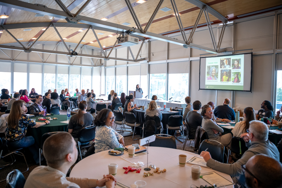 photo of tables and people at symposium