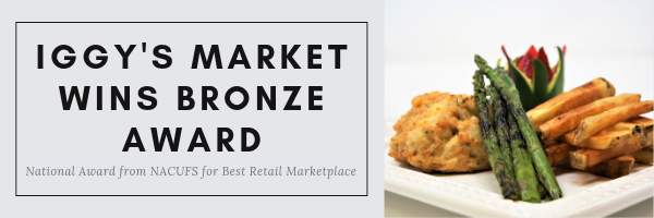 Crab cake and veggies with text: 'Iggy's Market Wins Bronze Award National Award from NACUFS for Best Retail Marketplace'