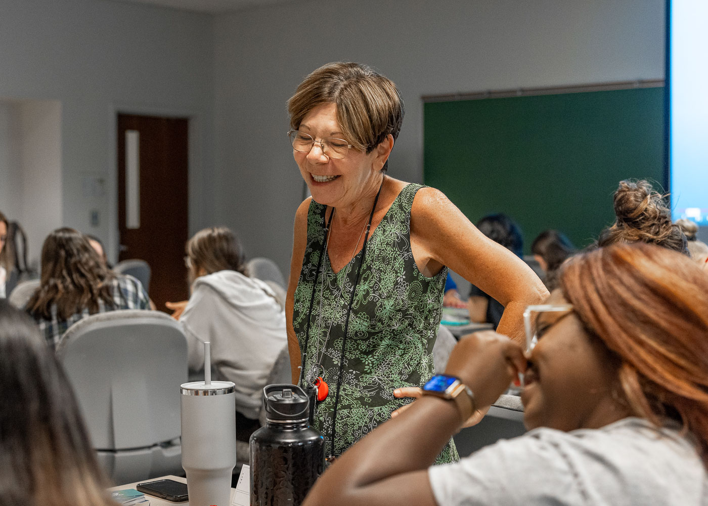 Professor and students smiling and laughing