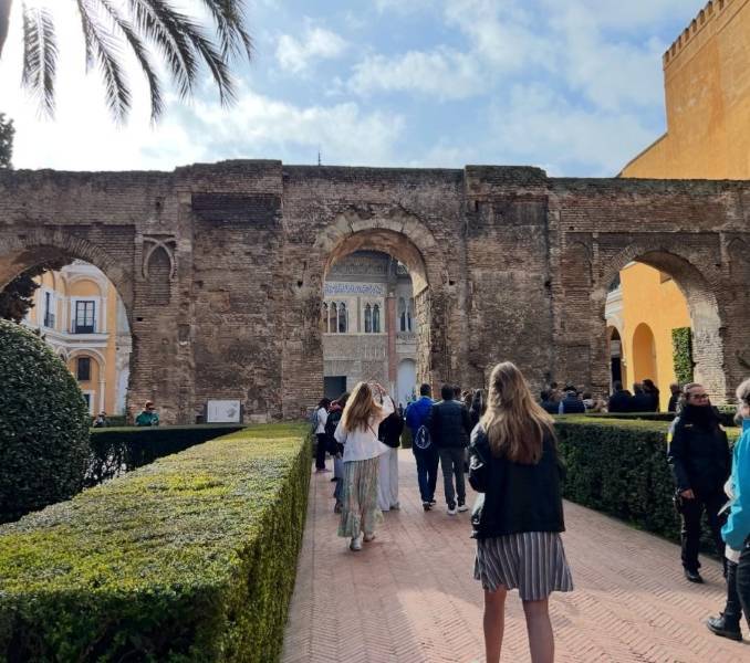 Students walking through an archway in Spain