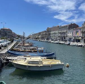 A canal in Montpellier, France with boats surrounding the canal