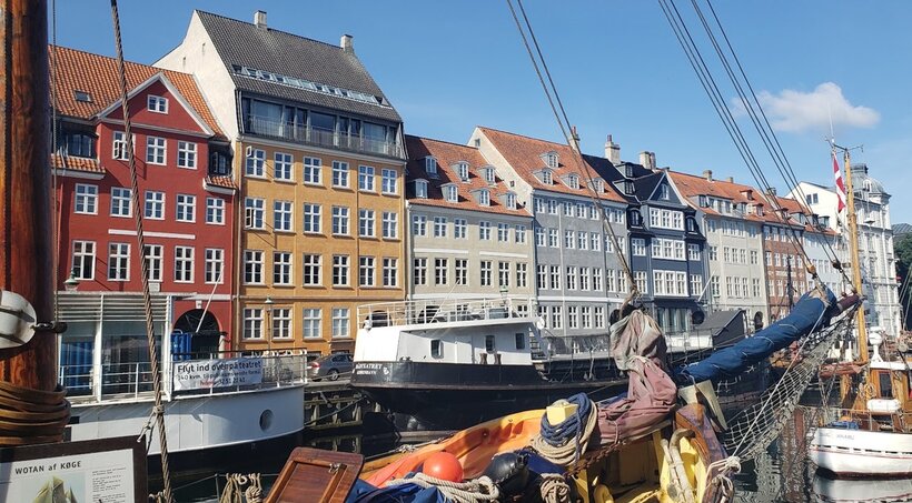 Nyhavn, the main port in Copenhagen with boats and lots of colorful buildings.