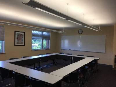 Tables arranged in rectangle, whiteboard