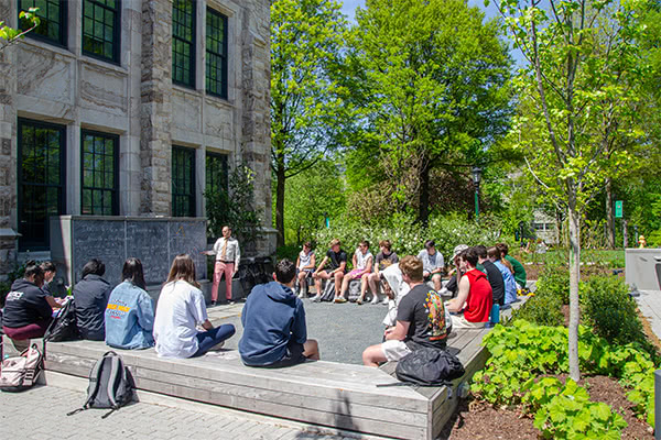 lecture being given to college students outside 