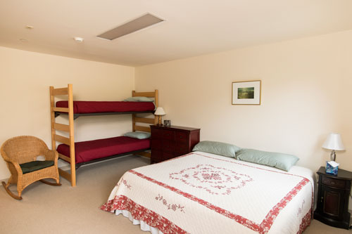 View of buttercup room with full bedroom and bunk bed
