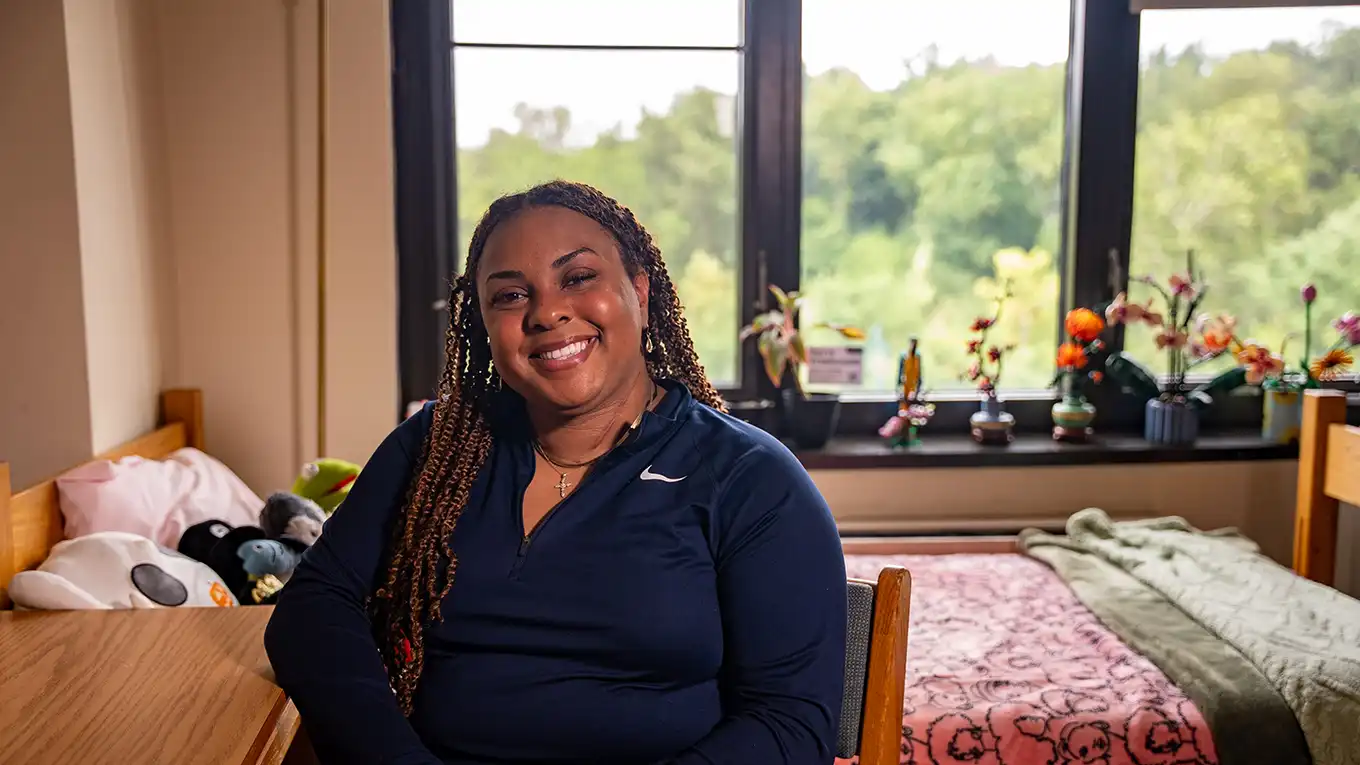 Newman towers resident welcomes Loyola to their dorm. - Press enter to play