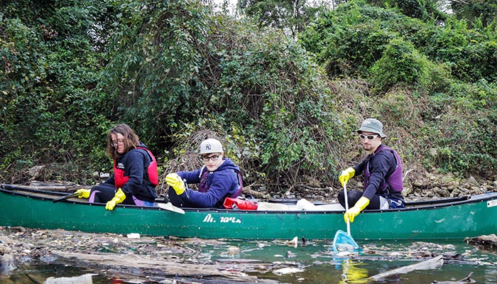 Student clean up in a canoe 