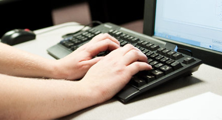 Student typing on keyboard